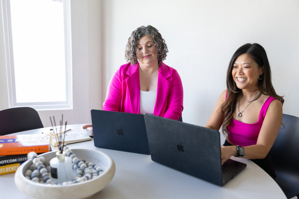 Greta and Judy from Bringing Simplicity laughing during a branding session, showcasing authentic connection and joy in business